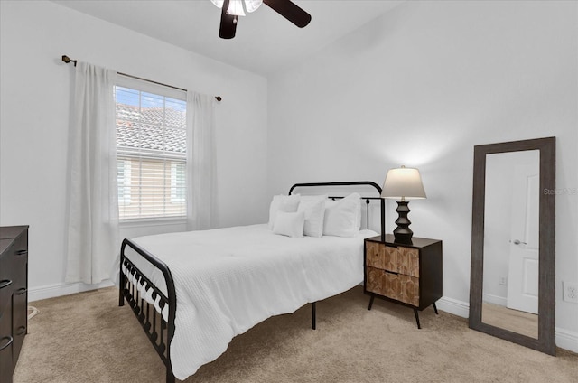 bedroom with ceiling fan, carpet floors, and baseboards