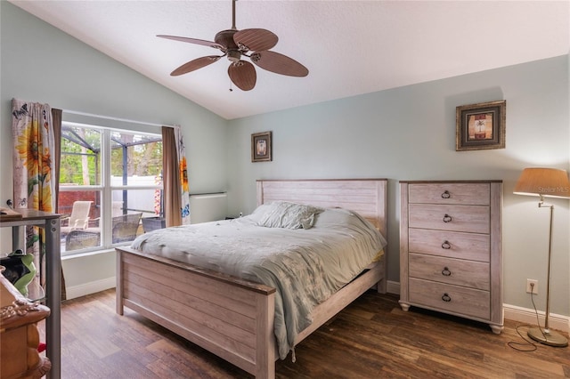 bedroom featuring dark wood finished floors, vaulted ceiling, and baseboards