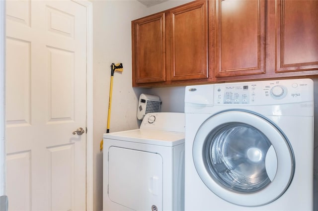 washroom with cabinet space and independent washer and dryer