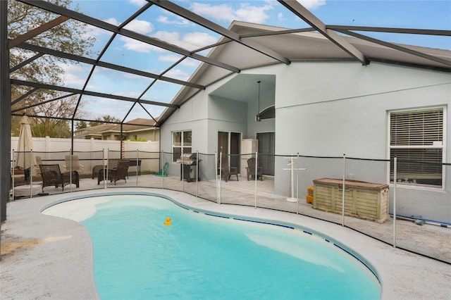 view of pool featuring a patio area, a lanai, a fenced in pool, and fence