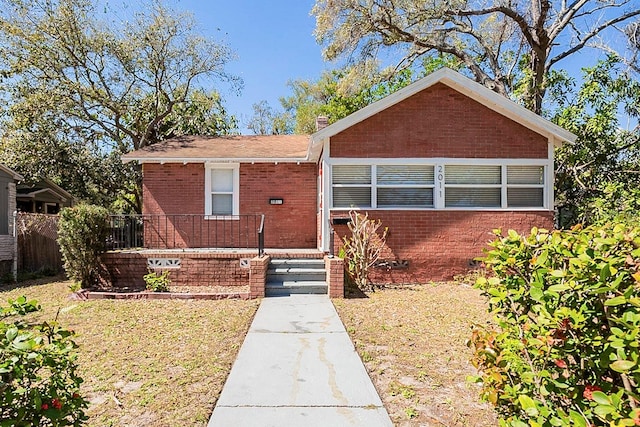 bungalow-style house featuring brick siding