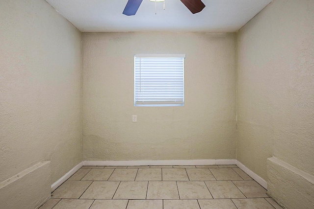 unfurnished room featuring light tile patterned floors, baseboards, and ceiling fan