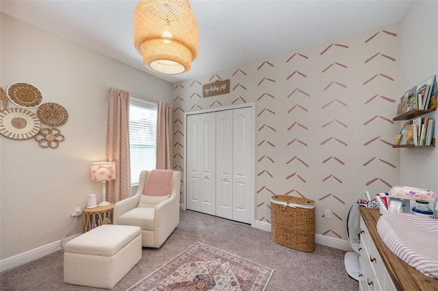 carpeted bedroom with wallpapered walls, baseboards, and a closet