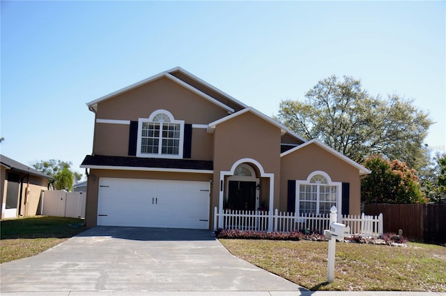 traditional-style home with stucco siding, concrete driveway, an attached garage, fence, and a front lawn