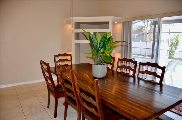 dining area with light tile patterned floors and baseboards