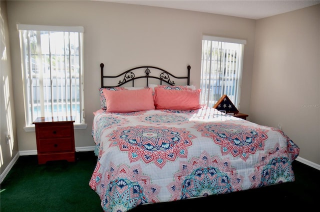 carpeted bedroom featuring baseboards