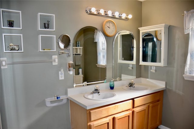 bathroom featuring double vanity and a sink