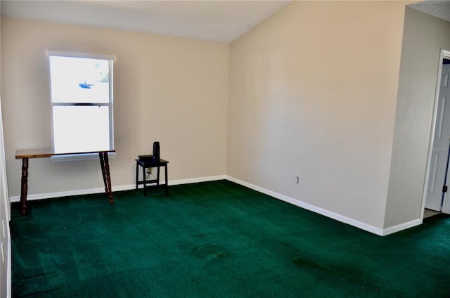 unfurnished room with baseboards and dark carpet