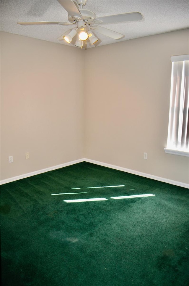 spare room featuring a ceiling fan, carpet flooring, a textured ceiling, and baseboards