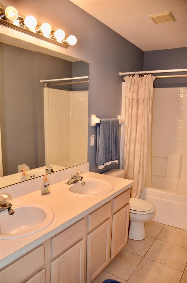 bathroom with toilet, tile patterned flooring, a sink, and visible vents