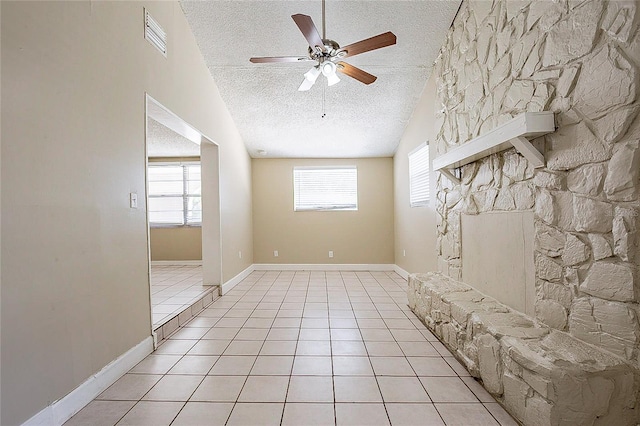 mudroom with light tile patterned floors, visible vents, a ceiling fan, vaulted ceiling, and a textured ceiling