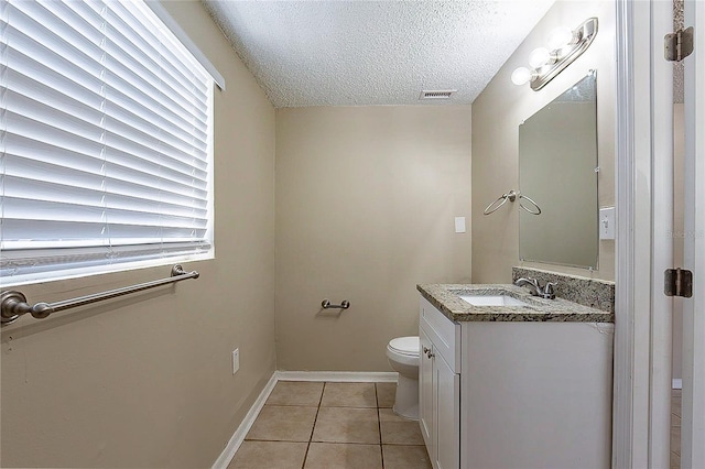 half bathroom with visible vents, toilet, tile patterned floors, a textured ceiling, and vanity