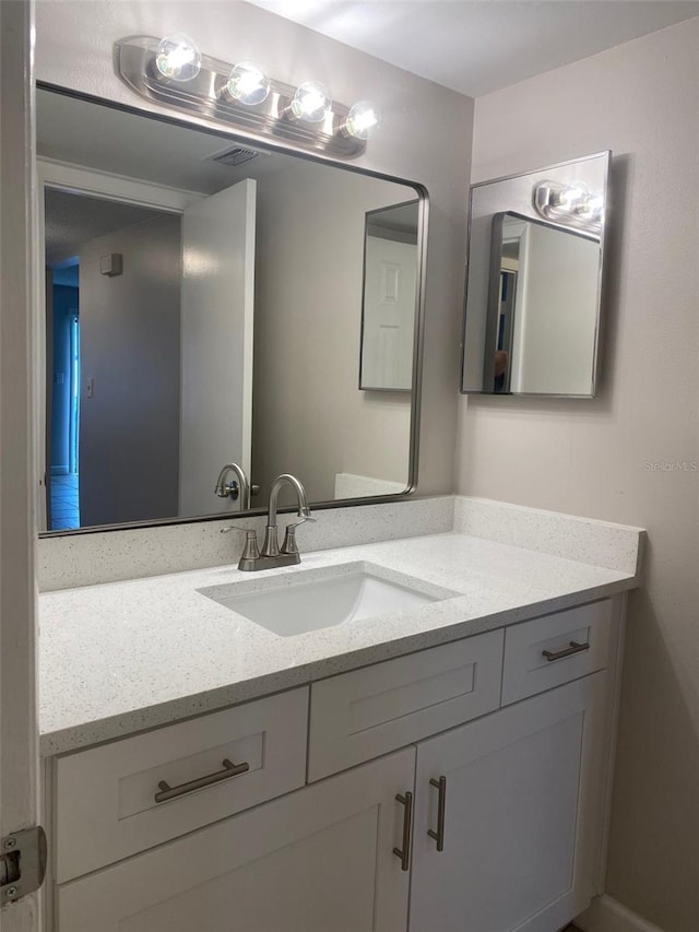 bathroom with visible vents and vanity