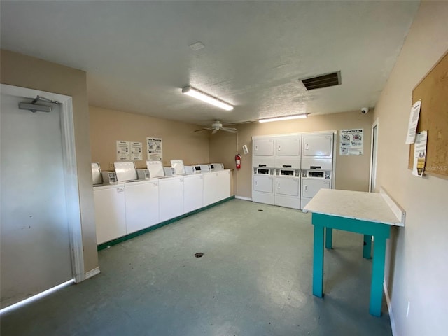 garage featuring a ceiling fan, visible vents, stacked washer / drying machine, and washing machine and clothes dryer