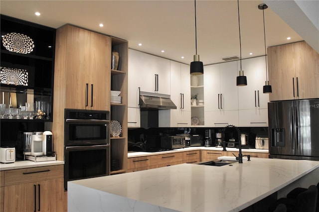 kitchen featuring pendant lighting, open shelves, light stone countertops, modern cabinets, and under cabinet range hood