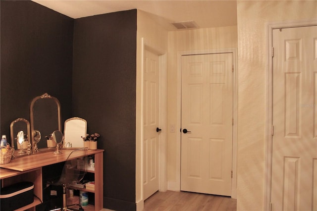 hall with light wood-type flooring and visible vents