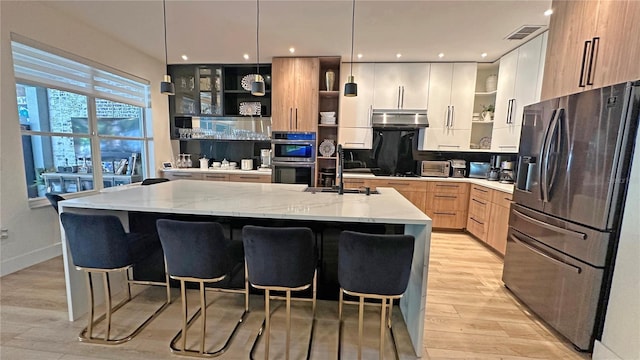 kitchen featuring stainless steel appliances, modern cabinets, light stone countertops, and open shelves