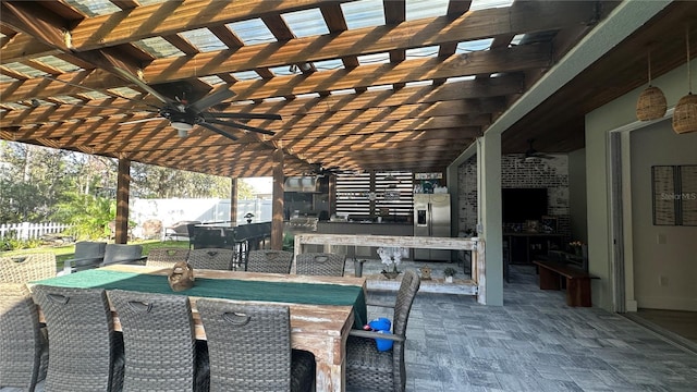 view of patio featuring ceiling fan, fence, outdoor dry bar, and a pergola