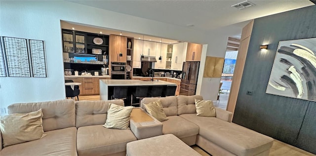 living area featuring built in shelves and visible vents