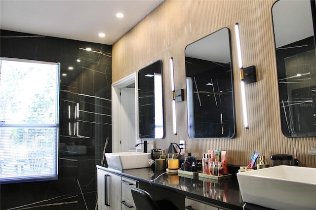 full bathroom featuring a sink and double vanity