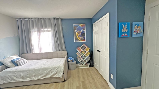 bedroom featuring a closet and light wood finished floors