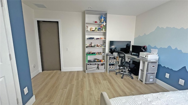 home office featuring light wood-style floors, visible vents, and baseboards