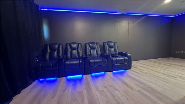 home theater room featuring light wood-style floors