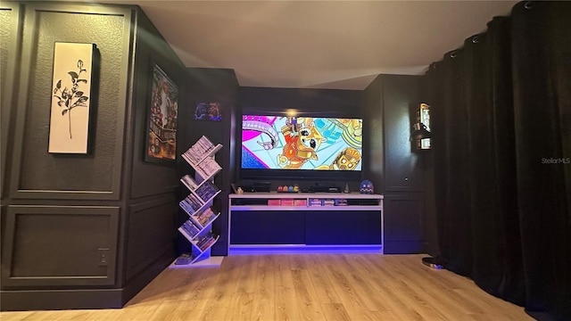 cinema room with light wood-style flooring