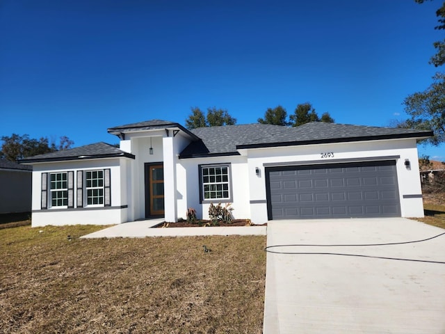 view of front facade featuring a front yard, driveway, an attached garage, and stucco siding