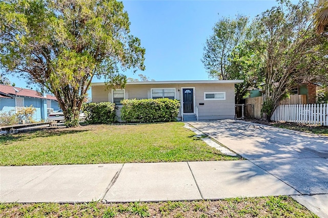 single story home with a front yard and fence