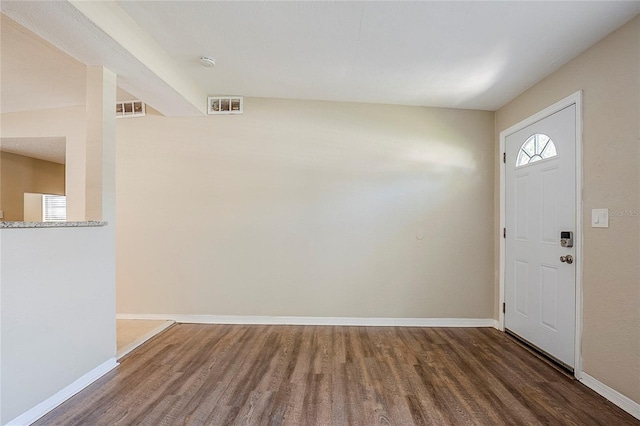 entrance foyer with visible vents, baseboards, and wood finished floors