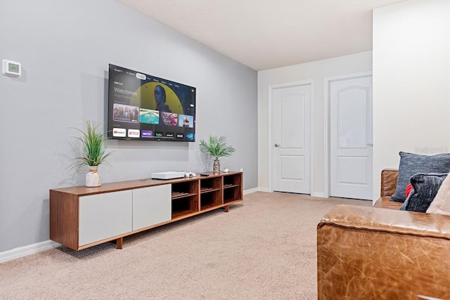 living room featuring carpet flooring and baseboards