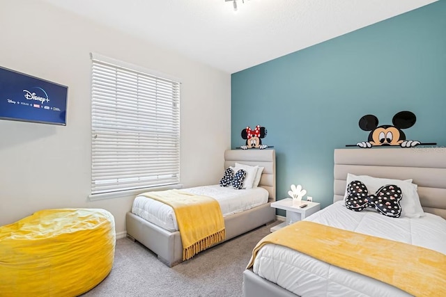 bedroom featuring carpet floors and baseboards