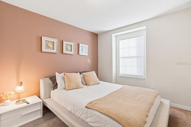 bedroom featuring carpet flooring and baseboards