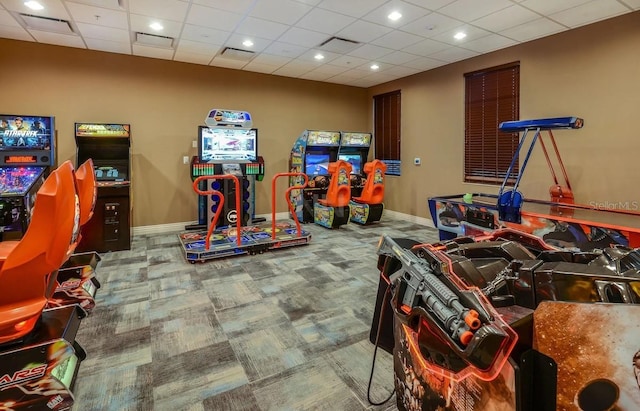 rec room with carpet, visible vents, a drop ceiling, and baseboards