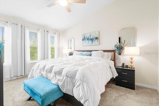 bedroom with vaulted ceiling, baseboards, a ceiling fan, and light colored carpet