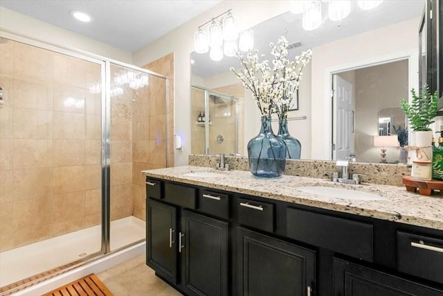 full bath with a stall shower, visible vents, a sink, and double vanity