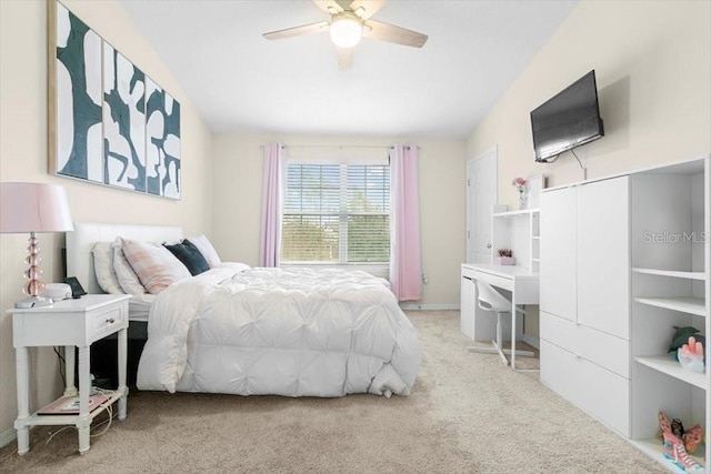 carpeted bedroom with vaulted ceiling and ceiling fan