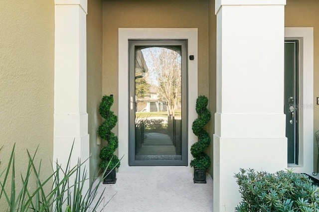 doorway to property with stucco siding