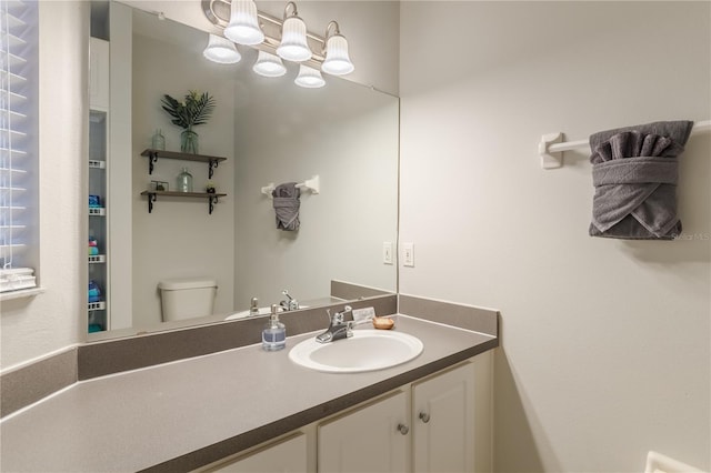 bathroom featuring toilet and vanity