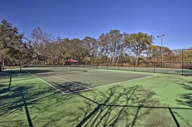 view of tennis court with fence