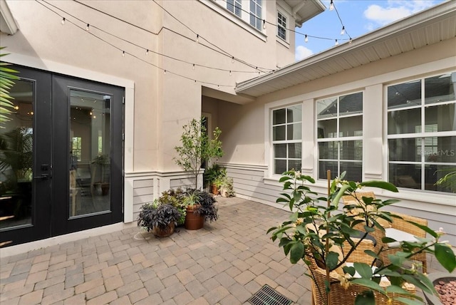 view of patio featuring french doors and visible vents