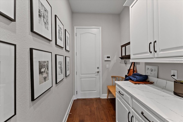 interior space featuring dark wood-style floors and baseboards