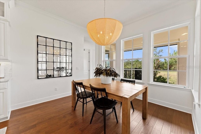 dining room featuring dark wood-style floors, baseboards, and crown molding