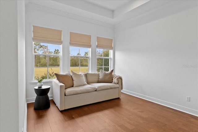 sitting room featuring plenty of natural light, wood finished floors, and baseboards