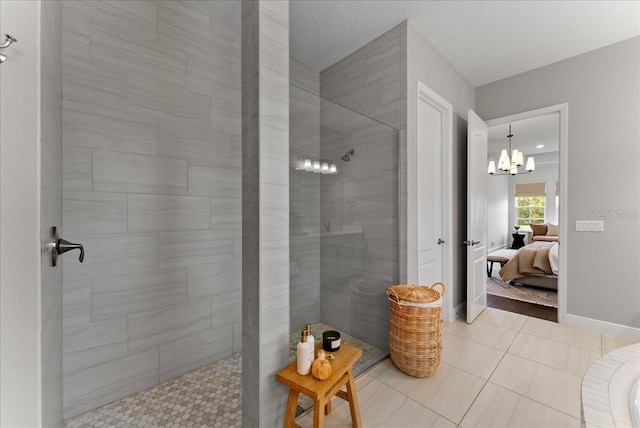 bathroom with baseboards, a walk in shower, connected bathroom, and tile patterned floors