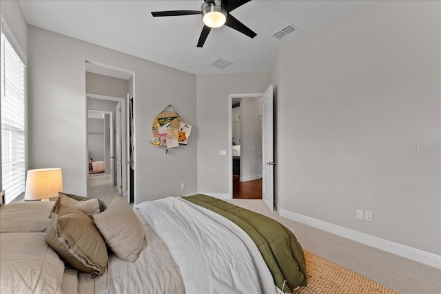 bedroom with multiple windows, carpet, visible vents, and baseboards