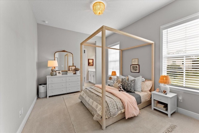 bedroom featuring light carpet and baseboards