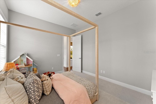 carpeted bedroom featuring visible vents and baseboards