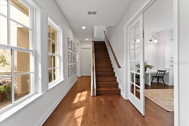 interior space featuring baseboards, visible vents, wood finished floors, and recessed lighting